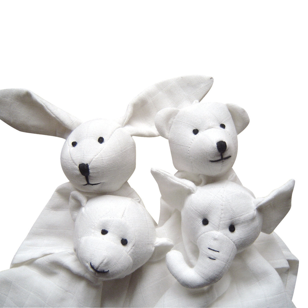 Four white organic cotton baby comforters shaped like a rabbit, a bear, a monkey, and an elephant, with black embroidered facial features, set against a plain white background.