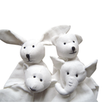 Four white organic cotton baby comforters shaped like a rabbit, a bear, a monkey, and an elephant, with black embroidered facial features, set against a plain white background.